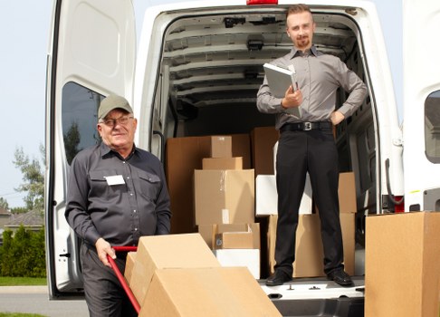 Trained movers handling furniture carefully in a residential property