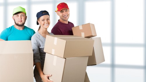 Careful furniture loading into a van for West London relocation