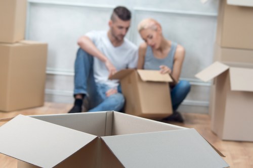 Movers organizing computers and office furniture during a Maidavale office move