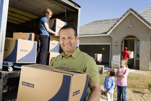 Packed office boxes and furniture ready for transport